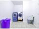 Functional laundry room featuring modern washer and dryer units, sink and tiled flooring at 2191 Jasmine Rd., Loris, SC 29569