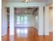 Open-concept living room with gleaming hardwood floors and abundant natural light from large windows at 2191 Jasmine Rd., Loris, SC 29569