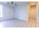 Bright living room with white tile floor, ceiling fan, and lots of natural light at 2191 Jasmine Rd., Loris, SC 29569