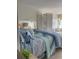 Comfortable bedroom featuring calming blue tones, a decorative screen, and ample natural light at 2204 South Perrin Dr. # 29, North Myrtle Beach, SC 29582