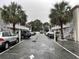 Condo building with parking, white stairs, and tropical landscaping at 2204 South Perrin Dr. # 29, North Myrtle Beach, SC 29582