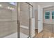 Modern bathroom with a glass-enclosed shower, built-in bench, and contemporary tile work at 2220 Flatleaf Ct, Longs, SC 29568