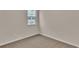 This bedroom has carpet flooring, light colored walls, and a single window that provides natural light at 2220 Flatleaf Ct, Longs, SC 29568