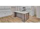 Modern kitchen with a large center island, stainless steel appliances, and ample cabinet space at 2220 Flatleaf Ct, Longs, SC 29568