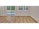 Spacious living area with bright windows and sliding glass door, with sleek flooring throughout at 2220 Flatleaf Ct, Longs, SC 29568