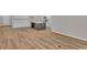 Bright, open-concept living area with a kitchen island and sleek flooring throughout at 2220 Flatleaf Ct, Longs, SC 29568