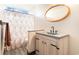 Stylish bathroom features a wooden vanity with modern sink, unique mirror, and decorative shower curtain at 2257 Huntingdon Dr. # H, Myrtle Beach, SC 29575