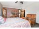 Charming bedroom with brick accent wall, wooden furniture, and sliding barn door to bathroom at 2257 Huntingdon Dr. # H, Myrtle Beach, SC 29575