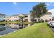Exterior of the condo building overlooking the community pond and well-maintained landscaping at 2257 Huntingdon Dr. # H, Myrtle Beach, SC 29575