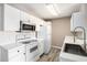 Bright kitchen with white appliances, white cabinets, and modern fixtures at 2257 Huntingdon Dr. # H, Myrtle Beach, SC 29575