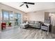 Cozy living room with wood flooring, stylish furniture, and a bright sunroom at 2257 Huntingdon Dr. # H, Myrtle Beach, SC 29575
