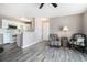 Open concept living room with white kitchen, wood flooring, neutral walls, and stylish furniture at 2257 Huntingdon Dr. # H, Myrtle Beach, SC 29575