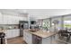Modern kitchen with stainless steel appliances, granite countertops, white cabinets, island seating and an open floor plan at 226 Ladyfish Loop, Sunset Beach, NC 28468