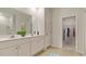 Bathroom with double sinks, granite countertops, and a walk-in closet at 234 Ladyfish Loop, Sunset Beach, NC 28468