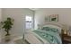 Bright and airy bedroom featuring a cozy bed, decorative pillows, and natural light from the window at 234 Ladyfish Loop, Sunset Beach, NC 28468