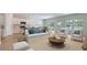 Open-concept living room featuring a modern kitchen, dining area and comfortable seating with lots of natural light at 234 Ladyfish Loop, Sunset Beach, NC 28468