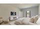 Neutral bedroom with a TV, cushioned chair, and an open doorway to the bathroom or closet at 234 Ladyfish Loop, Sunset Beach, NC 28468