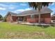The exterior of a brick house features a concrete patio and well-manicured lawn at 2384 Covington Dr., Myrtle Beach, SC 29579