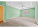 This spacious bedroom features a ceiling fan, a large window, and neutral carpeting at 2384 Covington Dr., Myrtle Beach, SC 29579