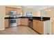 Modern kitchen featuring granite countertops, stainless steel appliances, and abundant wooden cabinetry at 2384 Covington Dr., Myrtle Beach, SC 29579
