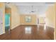 Open living room with hardwood floors, a ceiling fan, and natural light streaming through the windows creating a warm ambiance at 2384 Covington Dr., Myrtle Beach, SC 29579