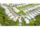 Aerial view of a home with solar panels, a landscaped yard, and a circular driveway in a residential neighborhood at 277 Splendor Circle, Murrells Inlet, SC 29576