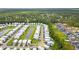 Aerial view of a community with well-maintained homes, a central pond, and lush landscaping at 277 Splendor Circle, Murrells Inlet, SC 29576