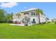 A spacious backyard, featuring a patio with lounge chairs and a grill for outdoor entertaining at 277 Splendor Circle, Murrells Inlet, SC 29576