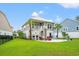Spacious backyard featuring outdoor patio space with palm trees and lounge chairs, perfect for relaxing at 277 Splendor Circle, Murrells Inlet, SC 29576