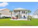Inviting backyard boasts an outdoor patio with a grill, lounge chairs, and ample space to relax at 277 Splendor Circle, Murrells Inlet, SC 29576
