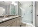 Bright bathroom featuring a double sink vanity with a granite countertop and a tiled walk-in shower at 277 Splendor Circle, Murrells Inlet, SC 29576
