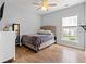 Bright bedroom with hardwood floors, ceiling fan, and a comfortable upholstered bed with a window view at 277 Splendor Circle, Murrells Inlet, SC 29576