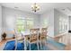 Bright dining room featuring a white table and chairs, wainscoting, and a large window at 277 Splendor Circle, Murrells Inlet, SC 29576