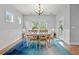 Charming dining area with white furniture, chandelier, and an area rug with backyard views at 277 Splendor Circle, Murrells Inlet, SC 29576