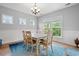 Bright dining room featuring a white table and chairs, wainscoting, and multiple windows at 277 Splendor Circle, Murrells Inlet, SC 29576