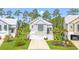 Charming coastal home featuring a two-car garage and well-manicured lawn at 277 Splendor Circle, Murrells Inlet, SC 29576