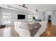 Large, bright living room with hardwood floors, white sofa, tray ceiling with ceiling fans, and natural light at 277 Splendor Circle, Murrells Inlet, SC 29576