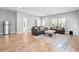 Spacious living room with hardwood floors, gray sofas, patterned rug, and natural light at 277 Splendor Circle, Murrells Inlet, SC 29576