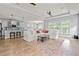 Bright and spacious living room with hardwood floors, a large white sofa, and an open concept kitchen at 277 Splendor Circle, Murrells Inlet, SC 29576