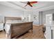 Bedroom featuring a ceiling fan, hardwood floors, tray ceiling, and an ensuite bathroom at 277 Splendor Circle, Murrells Inlet, SC 29576