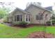 Back of home featuring windows, beige siding, and a small outdoor area at 3001 Dewberry Dr., Conway, SC 29527