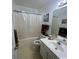 Well-lit bathroom featuring a vanity, mirror, and shower with white curtain at 3001 Dewberry Dr., Conway, SC 29527