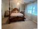 This cozy bedroom features a four-poster bed, decorative pillows, and natural light at 3001 Dewberry Dr., Conway, SC 29527