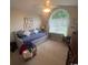 Bright bedroom with an arched window, comfortable seating, and carpeted floors at 3001 Dewberry Dr., Conway, SC 29527