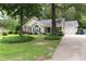 Inviting single-story home with a well-kept lawn, driveway, and decorative front yard at 3001 Dewberry Dr., Conway, SC 29527