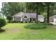 Charming single-story home with well-manicured lawn, lush landscaping, and inviting curb appeal at 3001 Dewberry Dr., Conway, SC 29527