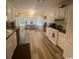 Bright kitchen boasts white cabinets, modern appliances, and natural light at 3001 Dewberry Dr., Conway, SC 29527