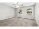 Spacious bedroom with neutral walls, plush carpet, and two windows at 315 73Rd Ave. N # 2, Myrtle Beach, SC 29572