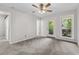 Bedroom featuring patio access through glass pane doors, window, and plush carpet at 315 73Rd Ave. N # 2, Myrtle Beach, SC 29572