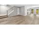 Bright living room featuring hardwood floors, modern gray walls, staircase, and a view into the kitchen at 315 73Rd Ave. N # 2, Myrtle Beach, SC 29572